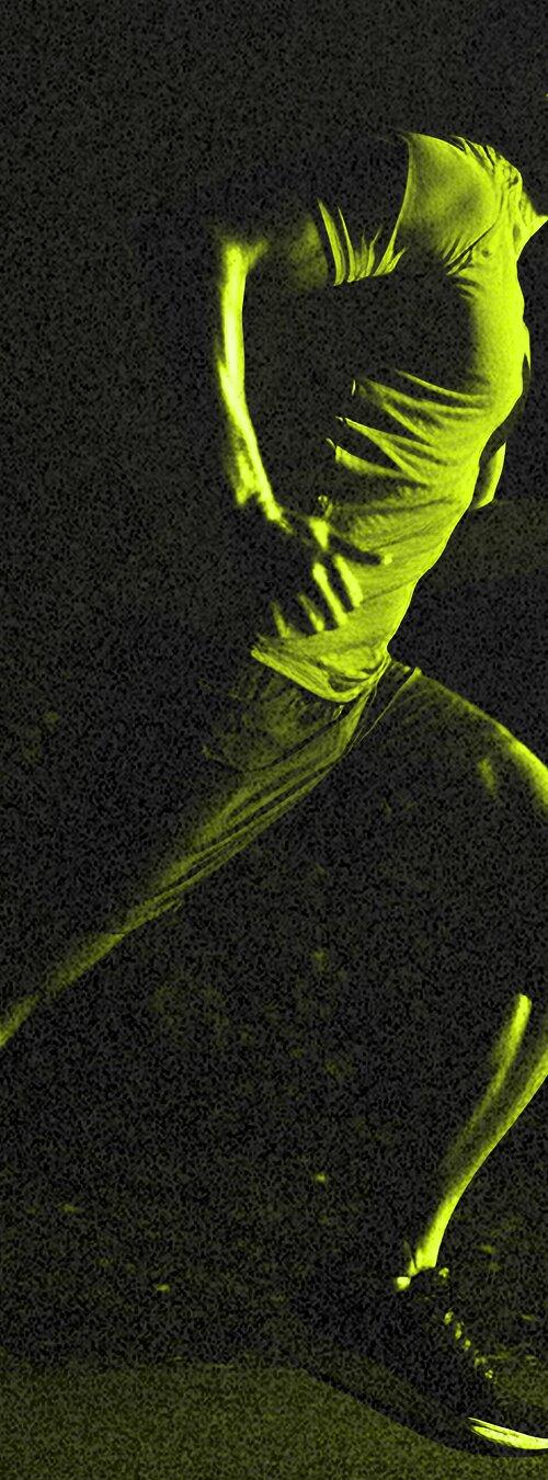 A runner mid stride at night, lit in acid green