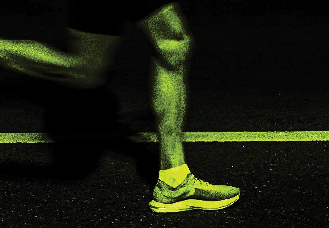 A runner's shoe planted on a glowing lane line at night, a second runner blurred behind